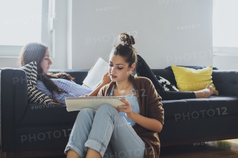 Caucasian women studying in living room