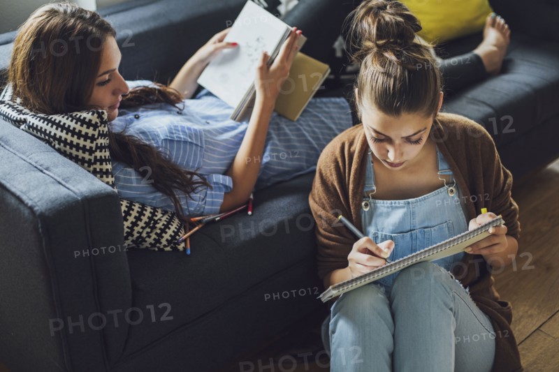 Caucasian women studying in living room