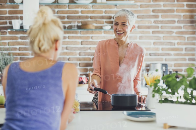 Women talking in kitchen