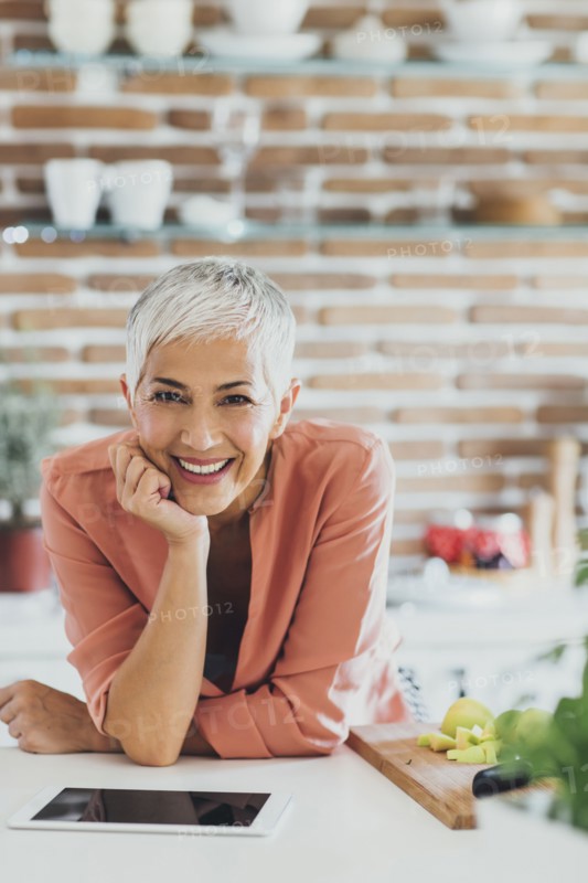 Older Caucasian woman smiling in kitchen