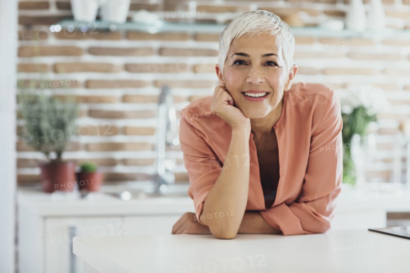 Older Caucasian woman smiling in kitchen