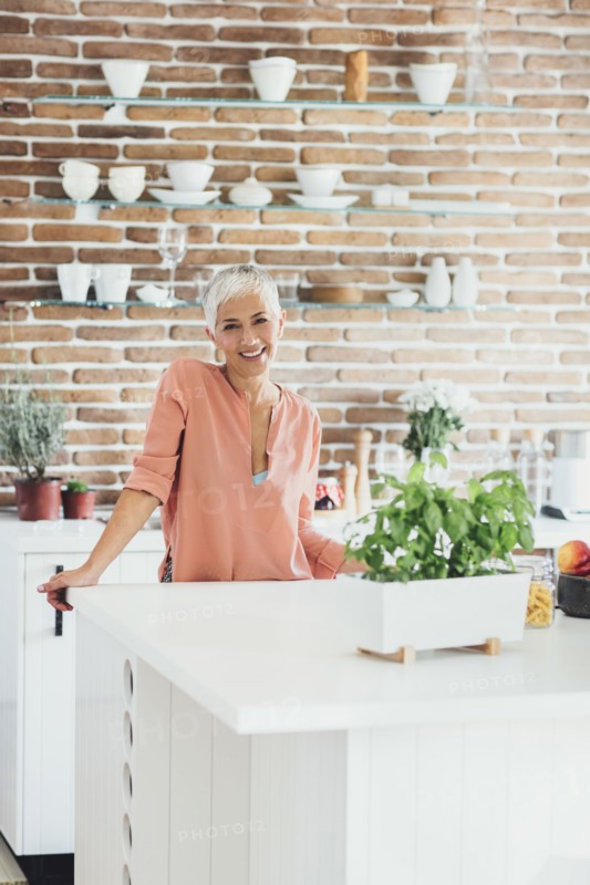 Older Caucasian woman smiling in kitchen