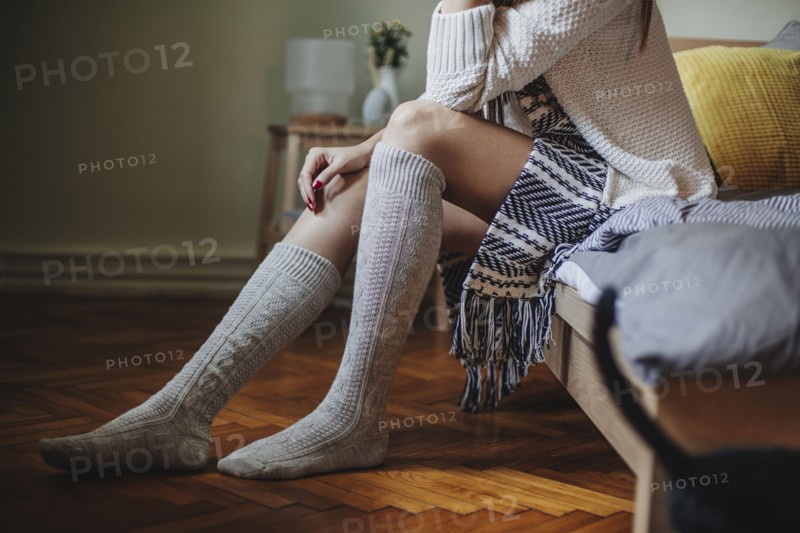 Caucasian woman sitting on bed