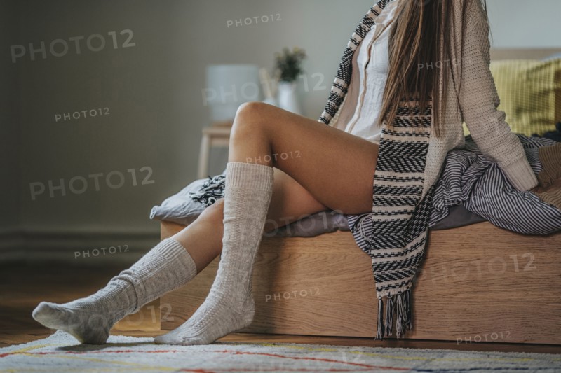 Caucasian woman sitting on bed