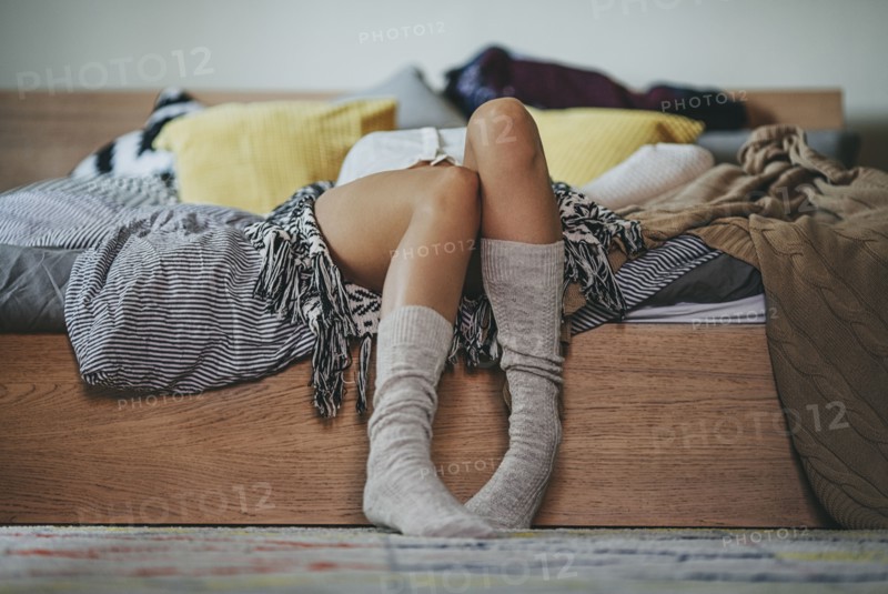 Caucasian woman laying on bed