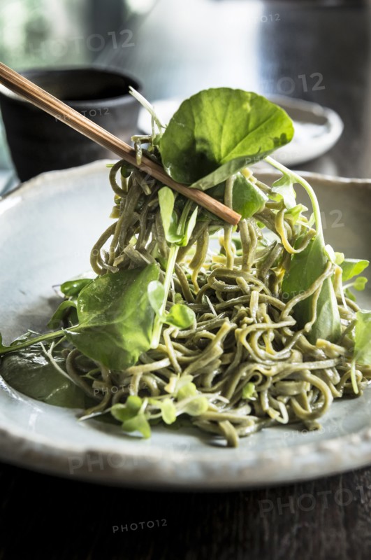 Chopsticks lifting soba salad noodles