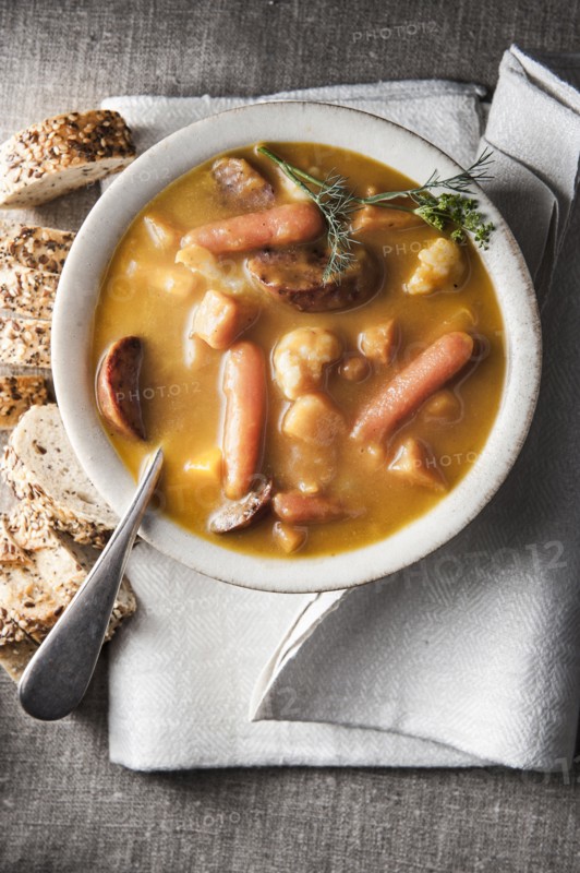 Bowl of stew with bread and napkin