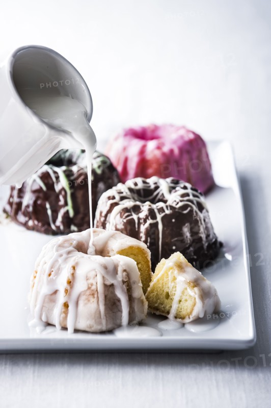 Icing pouring on miniature bundt cake