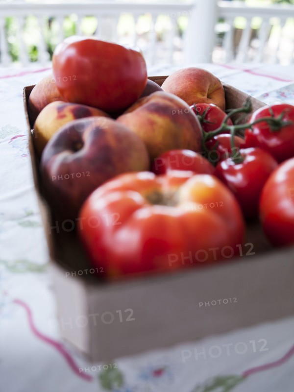 Box of fresh tomatoes and peaches