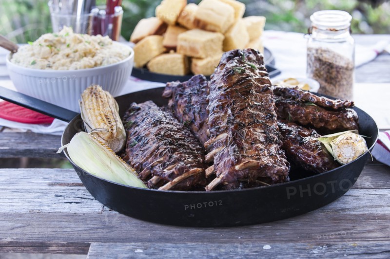 Pan of barbecue ribs on wooden table