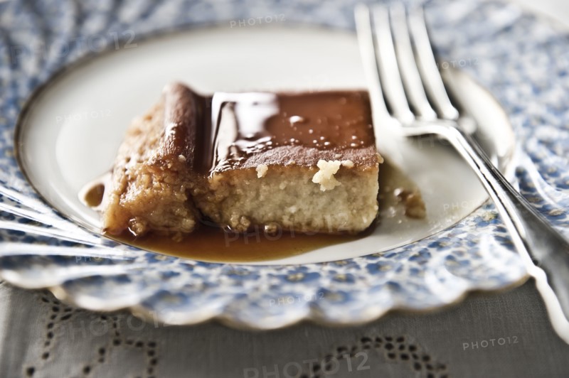 Flan on plate with syrup and fork