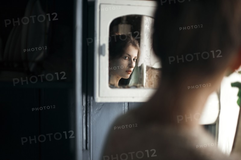 Caucasian woman admiring herself in mirror