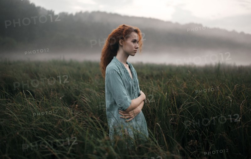 Caucasian woman standing in rural field