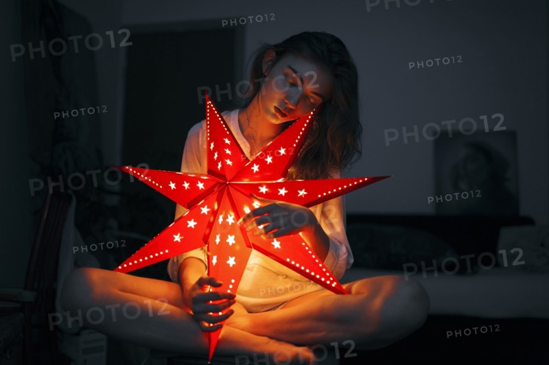 Caucasian woman holding glowing lantern