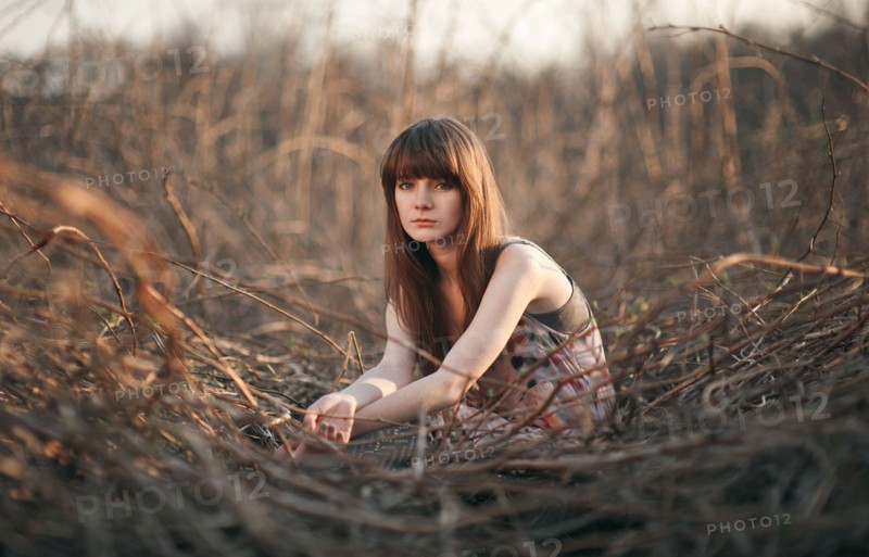 Caucasian woman sitting in field