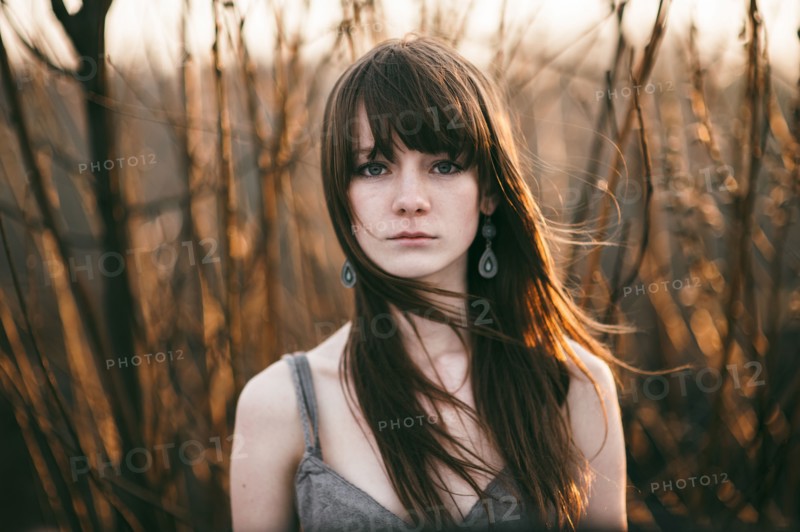 Caucasian woman standing in tall plants