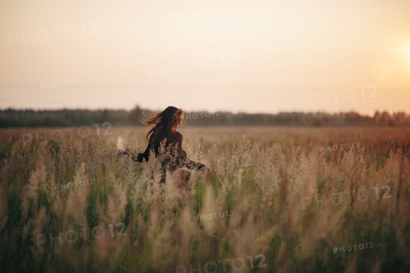 Caucasian woman walking in rural field
