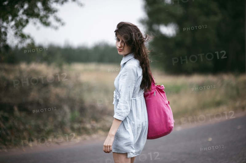 Caucasian woman walking on rural road