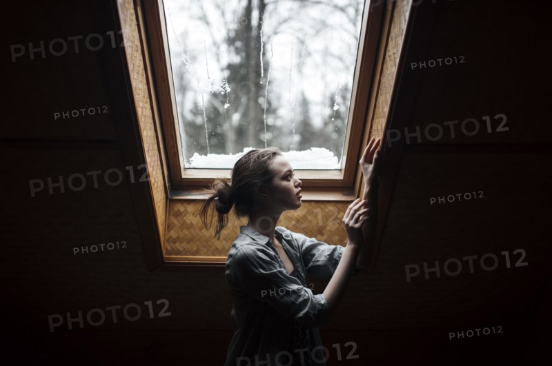 Caucasian woman standing under skylight