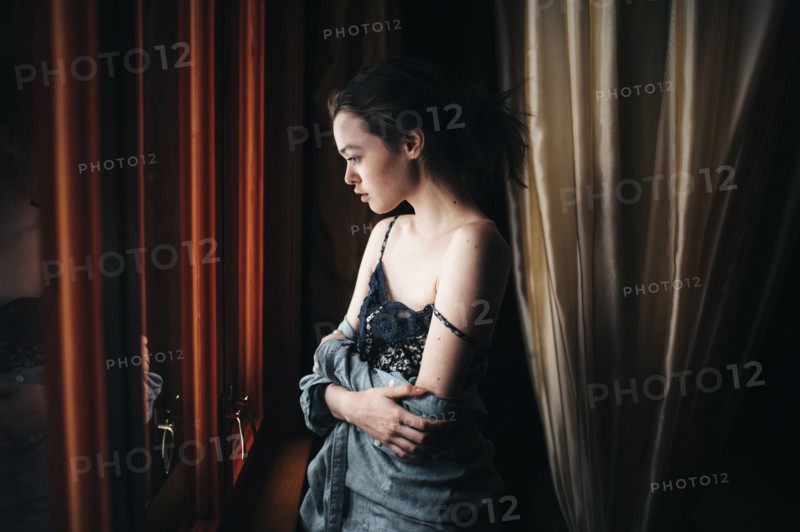 Caucasian woman looking out window