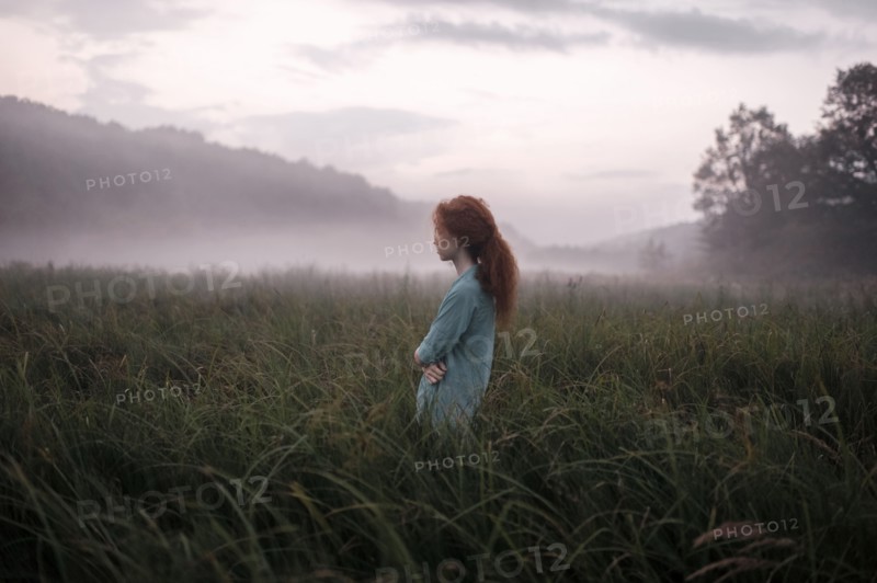 Caucasian woman standing in remote field