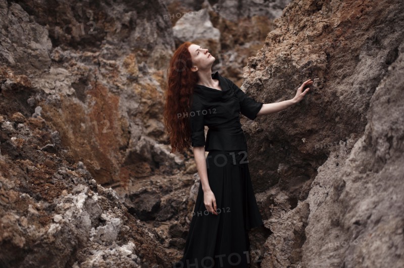 Caucasian woman walking on rocky hillside