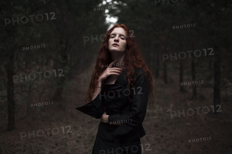 Caucasian woman walking on forest path