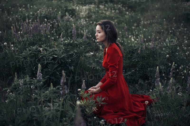 Caucasian woman sitting in field