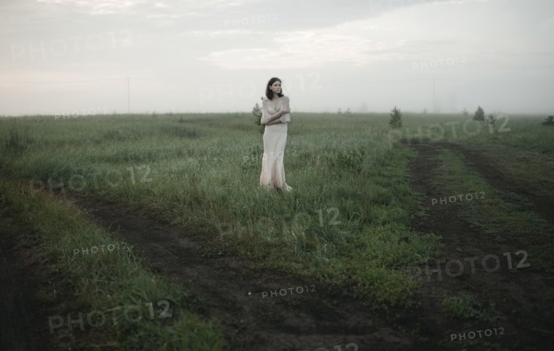 Caucasian woman standing in remote field