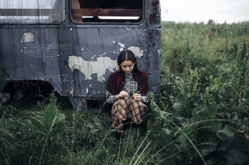Caucasian woman sitting near antique truck