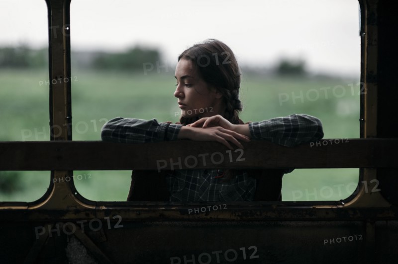 Caucasian woman leaning on empty bus