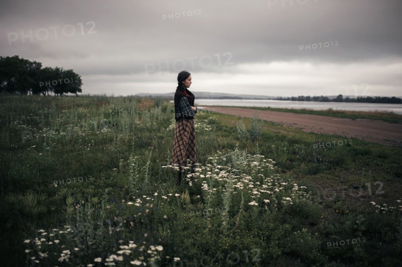 Caucasian woman standing in remote field