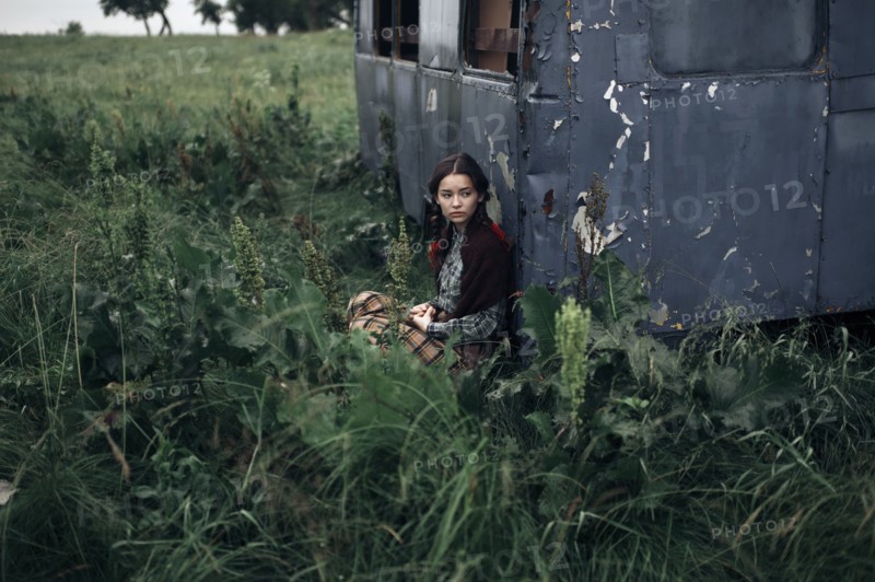 Caucasian woman sitting near remote field