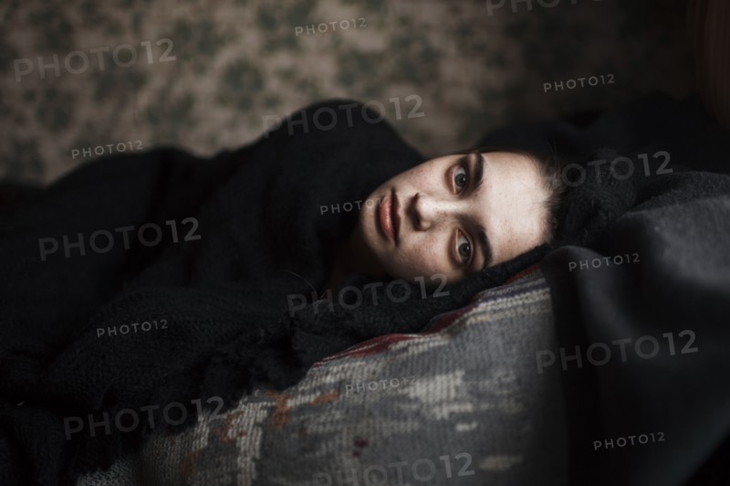 Caucasian woman laying on sofa