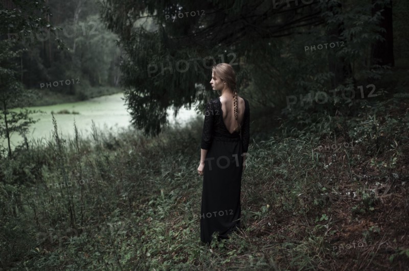 Caucasian woman standing on forest hillside