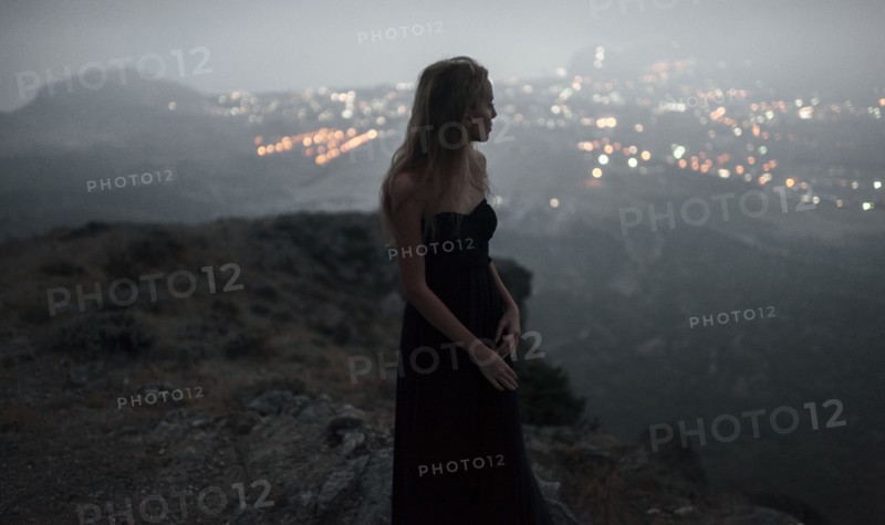 Caucasian woman on hilltop admiring cityscape view
