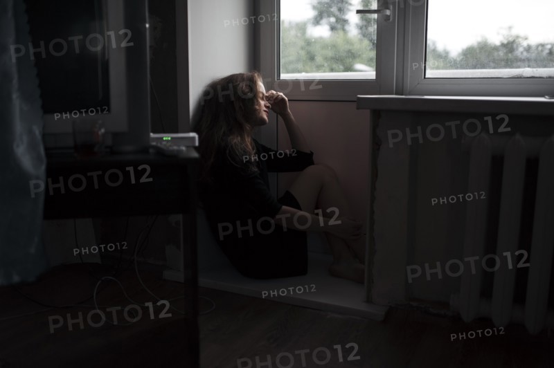Caucasian woman sitting near door