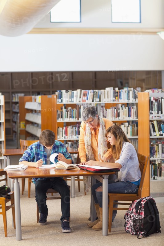 Librarian helping students in library
