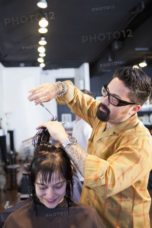 Hairdresser cutting hair in salon