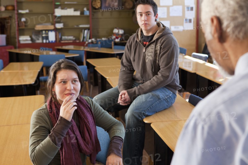 Teacher and students talking in classroom