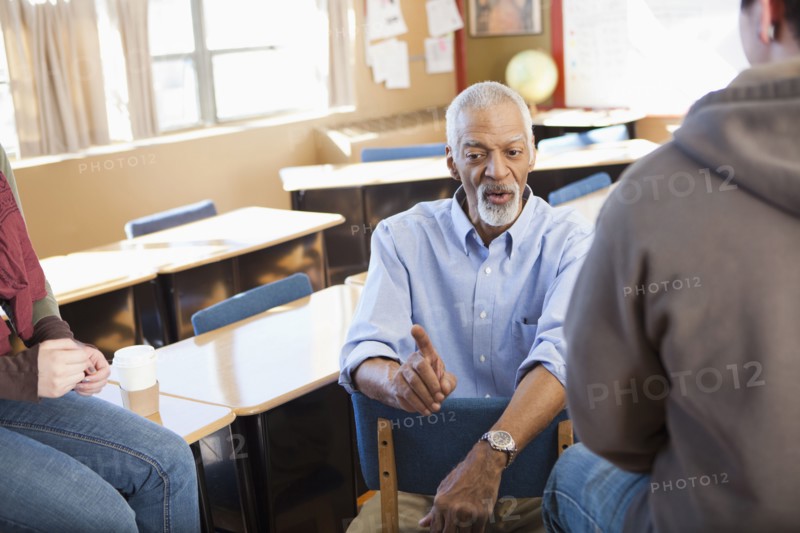 Teacher and students talking in classroom