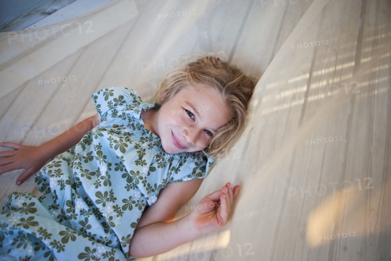 Caucasian girl laying in hammock