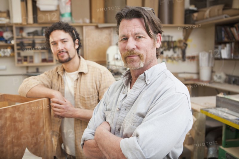Co-workers woodworking in workshop