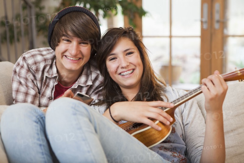 Mixed race couple sitting on sofa