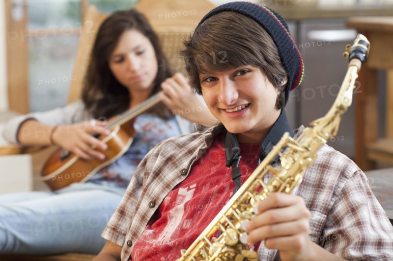 Mixed race teenagers playing musical instruments
