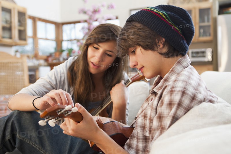 Mixed race friends playing ukulele