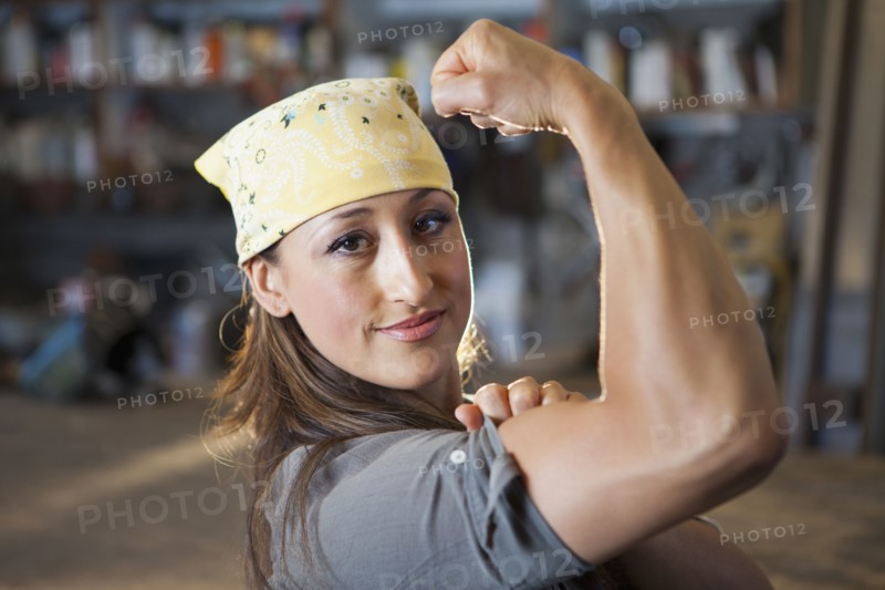 Hispanic worker flexing biceps