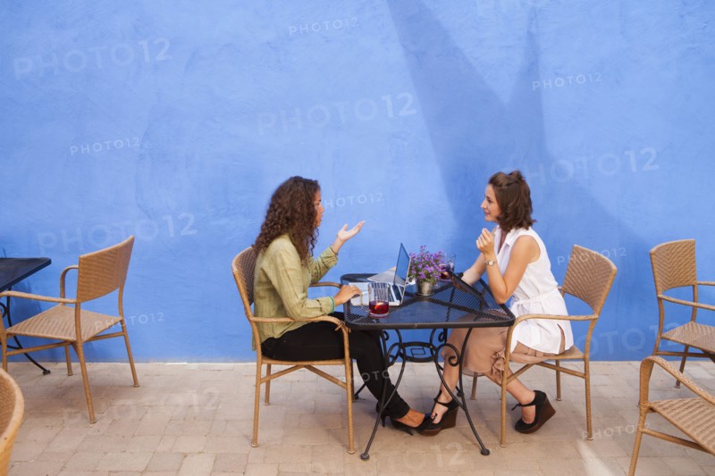 Businesswomen having meeting in outdoor cafe