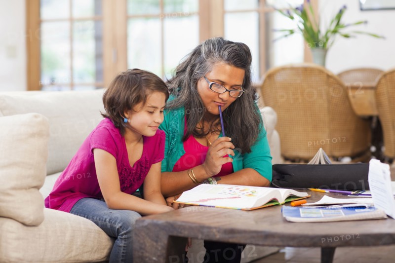 Mother helping daughter with homework