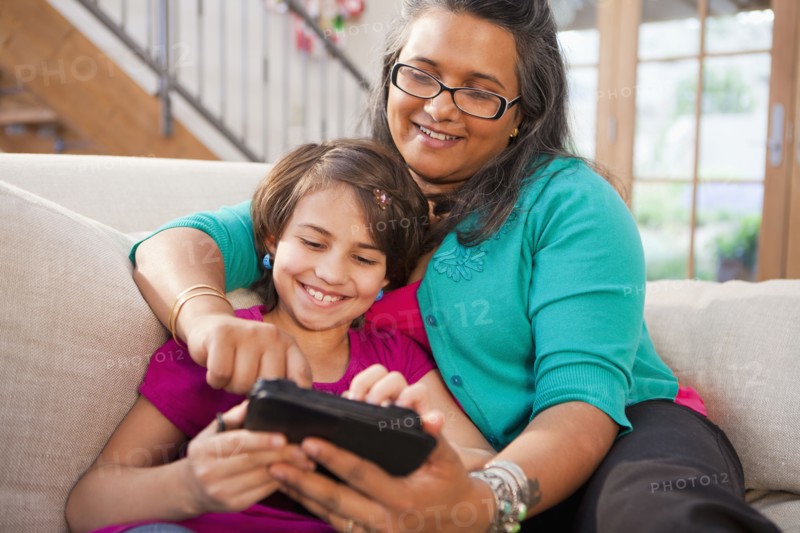 Mother and daughter using digital tablet